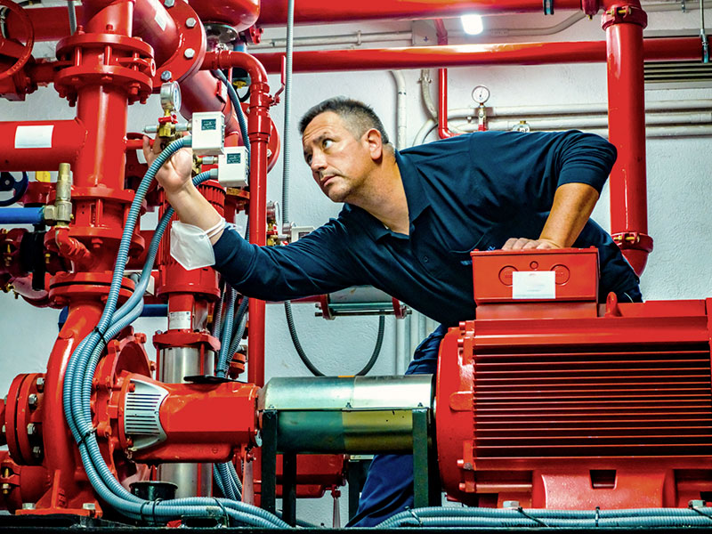 A technician inspecting a fire safety system